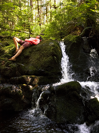 young woman resting near waterfall 400x533